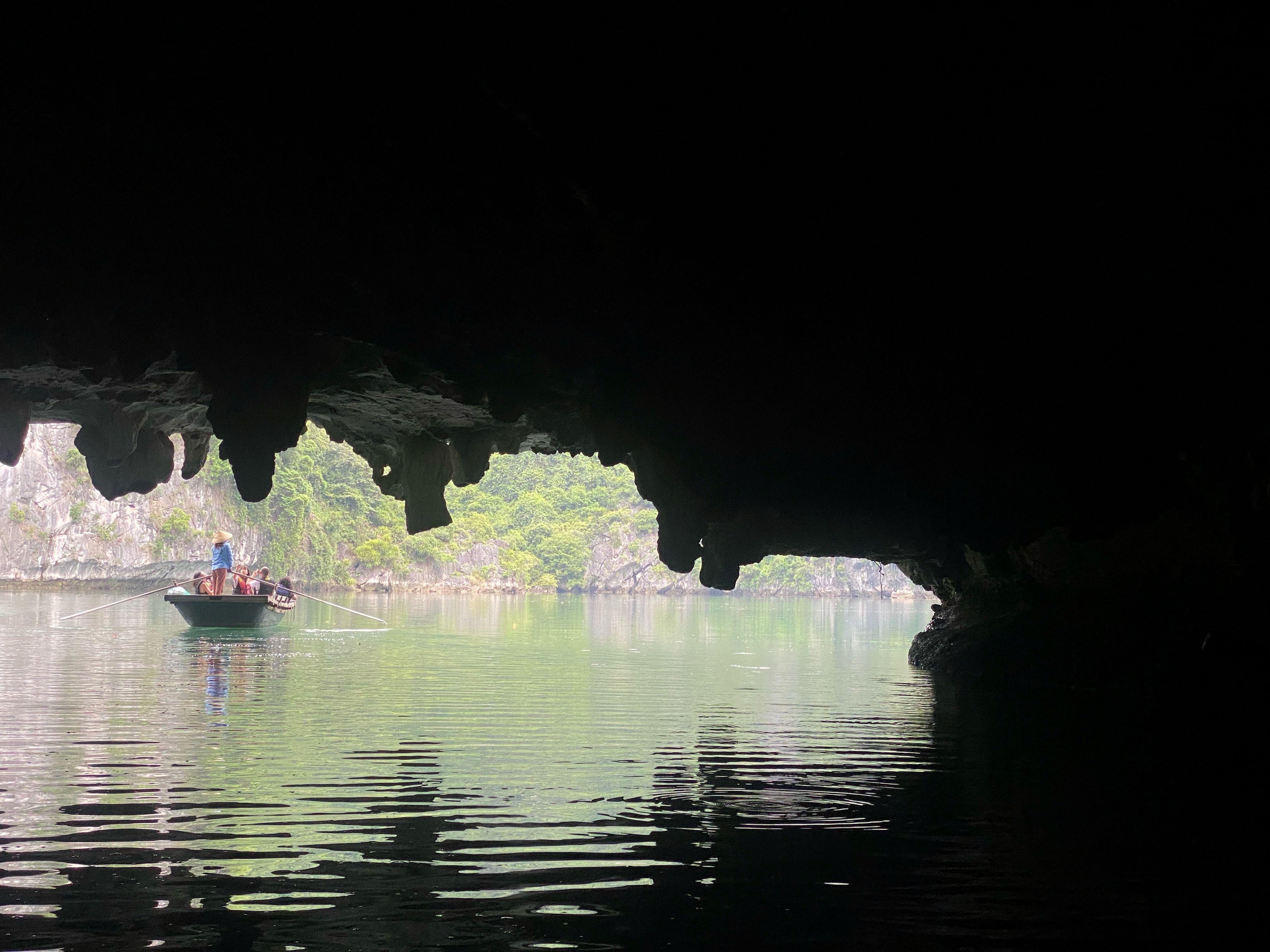 Boat passing into a sea cave - Ha Long, Vietnam