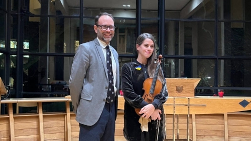 Delvyn (standing left) and violinist Emma-Marie in Fitzwilliam Chapel (window behind)