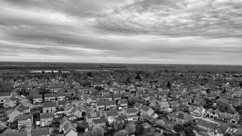 Aerial image of suburban England on overcast day, monochrome
