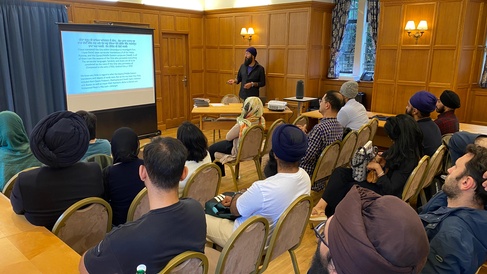 Satnam Singh presents to a seated audience
