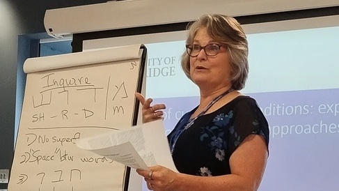 Shoshana gestures while explaining the Hebrew roots of inquiry (m-d-r-sh) and study buddies (h-v-r)