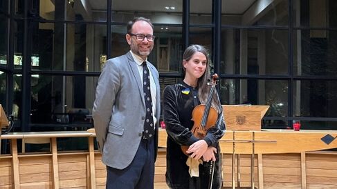 Delvyn (standing left) and violinist Emma-Marie in Fitzwilliam Chapel (window behind)