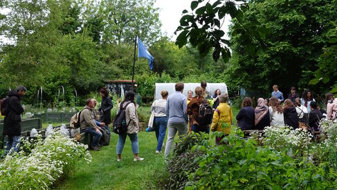 Photo of the Empty Common Community Garden with summer school participants
