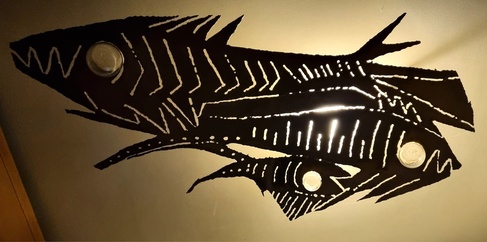 Three skeletal silhouettes of fish