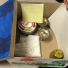 A box of objects primed to assist a young storyteller - a recipe for challah is visible