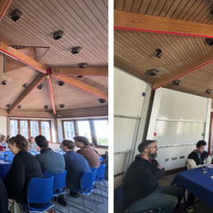 A diverse collective of young scholars seated around a blue table, under a wooden roof