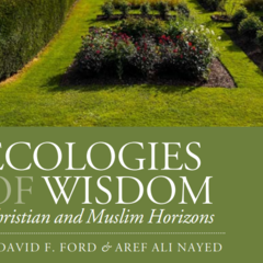 Photograph of a landscaped garden, with tended hedges, flowers, and grass.