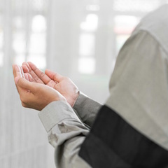 A Muslim man holding his hands together