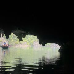 Boat passing into a sea cave - Ha Long, Vietnam