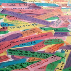 Strips of coloured paper with handwritten comments in German and English. Visible comments say "Kommunismus?" and "Feminism is the radical..."