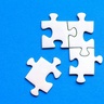 Four white puzzle pieces being assembled on blue background