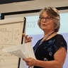 Shoshana gestures while explaining the Hebrew roots of inquiry (m-d-r-sh) and study buddies (h-v-r)
