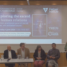 Esra at lectern gives welcome, panellists seated