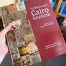 Detail of book cover, held to camera