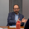 Daniel mid-speech, hands gesturing 