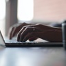 Hands on laptop keyboard