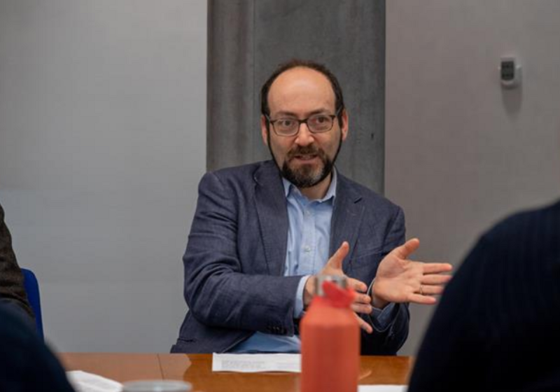 Daniel mid-speech, hands gesturing 