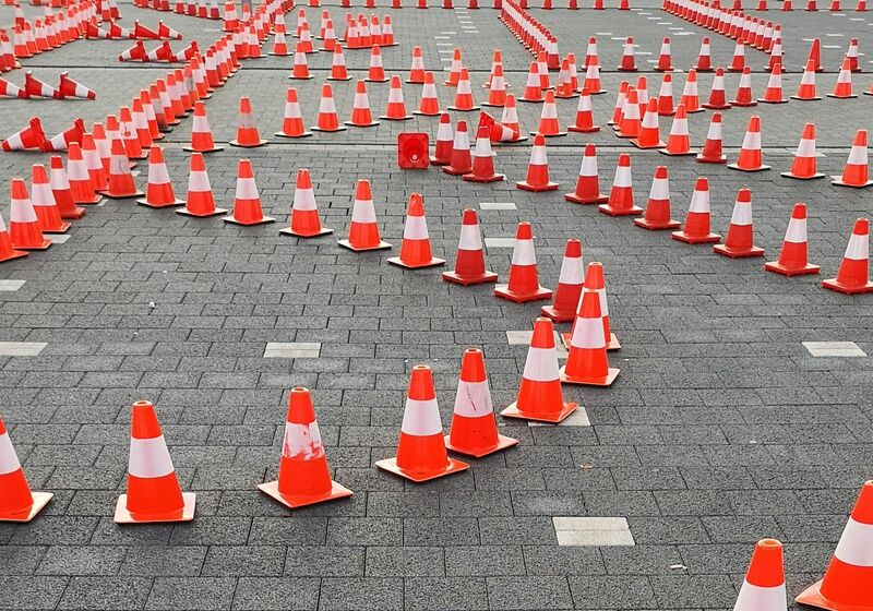 Intersecting lines of traffic cones indicating a complex pathway