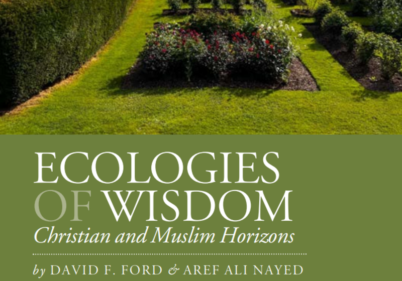 Photograph of a landscaped garden, with tended hedges, flowers, and grass.