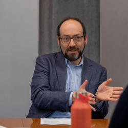 Daniel mid-speech, hands gesturing 