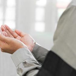 A Muslim man holding his hands together