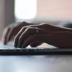 Hands on laptop keyboard