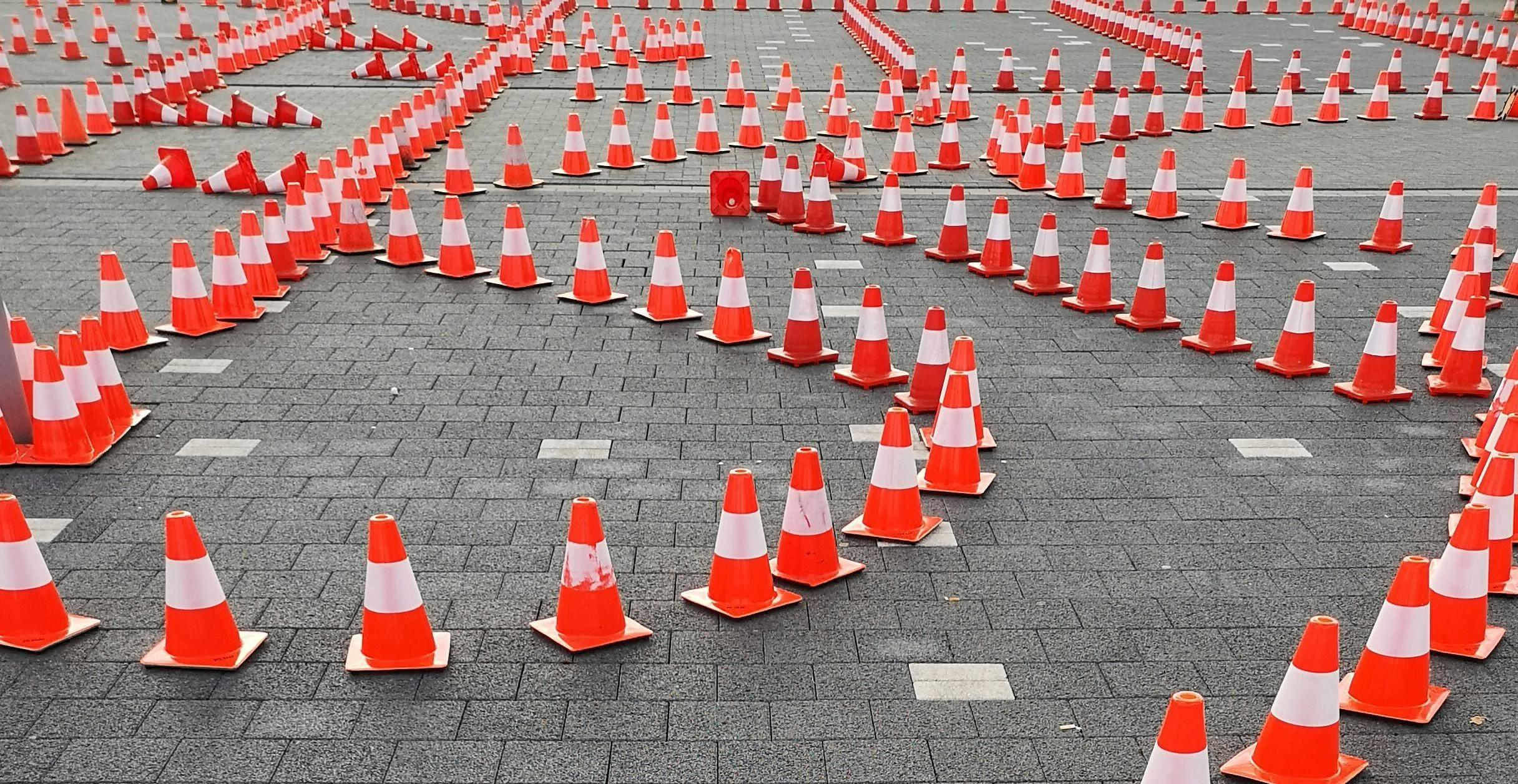 Detail from an original photograph by Ann H (2018), via pexels.com (2019) Intersecting lines of traffic cones indicating a complex pathway