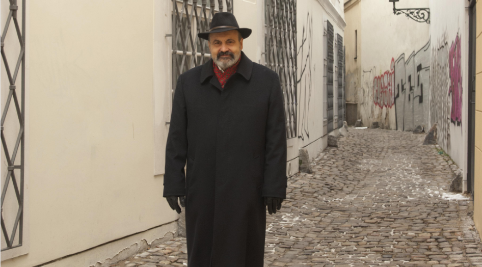 Detail from a photograph courtesy of Kristin Olson Literary Agency (halik.cz, 2024) Halik, in hat and coat, in a cobbled street