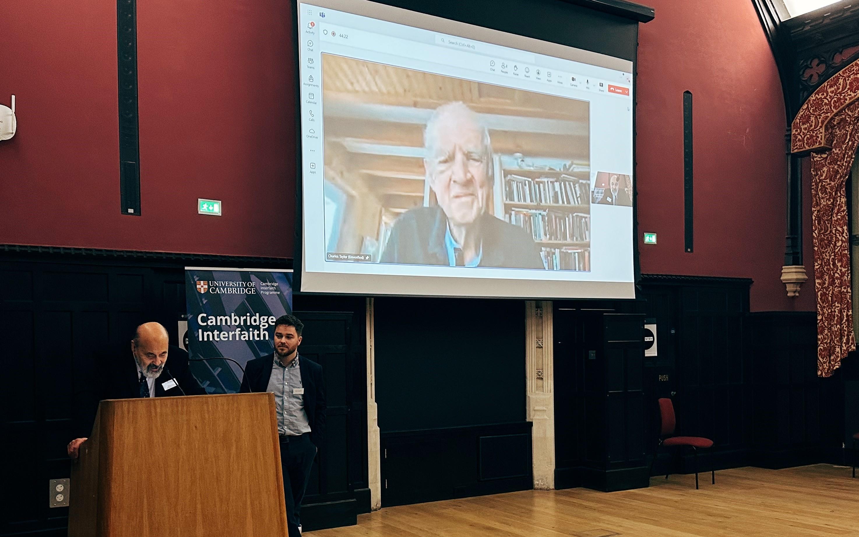 Halik, Cotterill and Taylor in Cambridge - original photo by Cole Bishop, 2024 Taylor (participating via livestream) watches as Halik responds