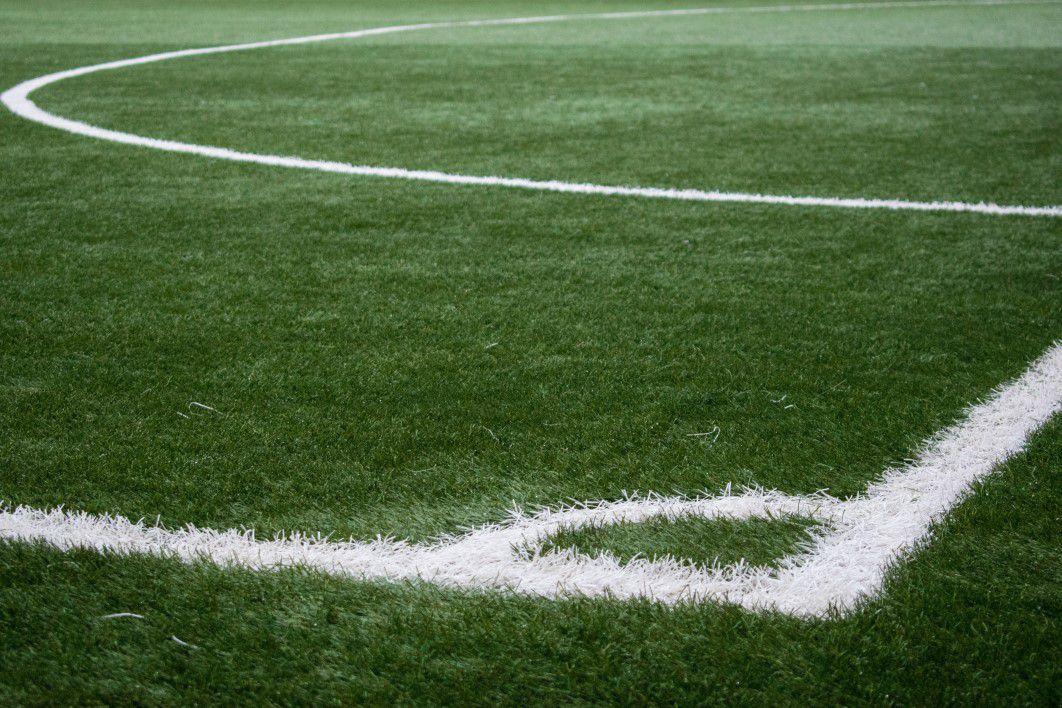 Football pitch corner — photograph courtesy of Lorenzo Cafaro (CC0) Painted white lines at the corner of a grass soccer pitch