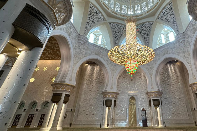 Inside the Mosque - photograph by Tilak Parekh (2023) Almost monochrome yet highly decorated, curved and abstract, the interior.