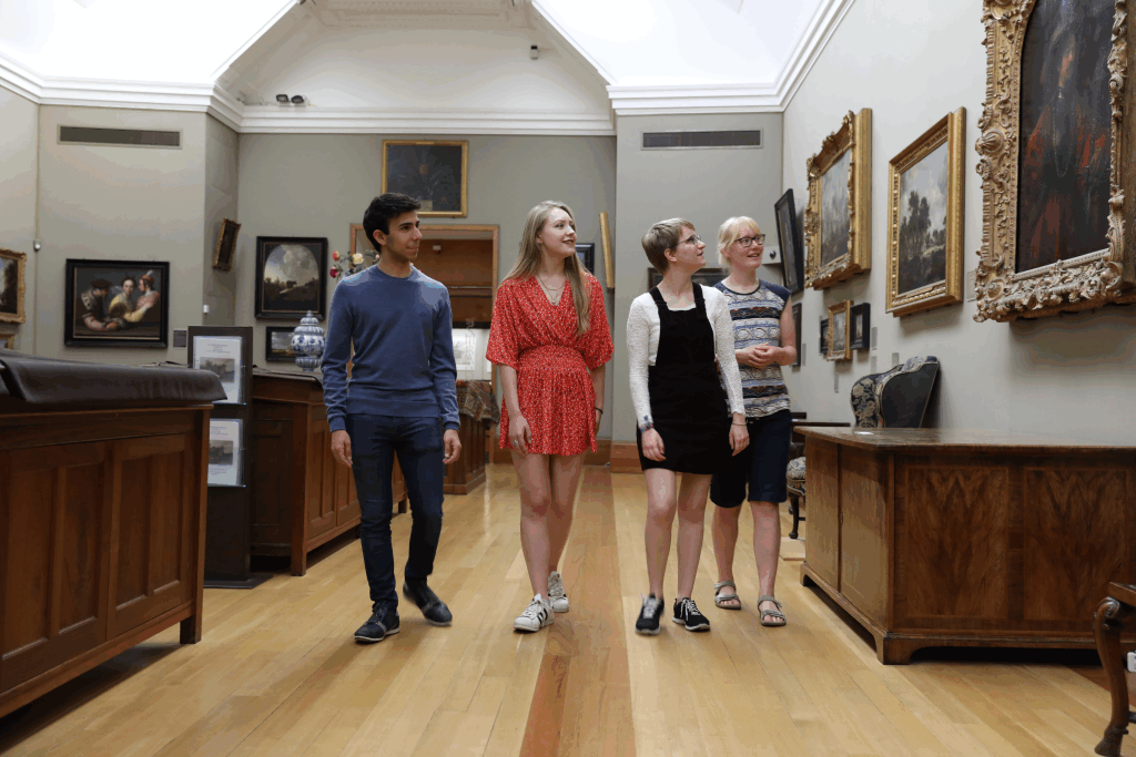 Four people in an art gallery