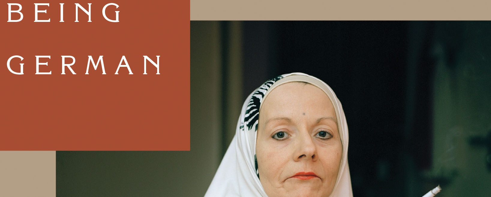 A white woman with a headscarf looks at the camera. To her left are the words "Being German".